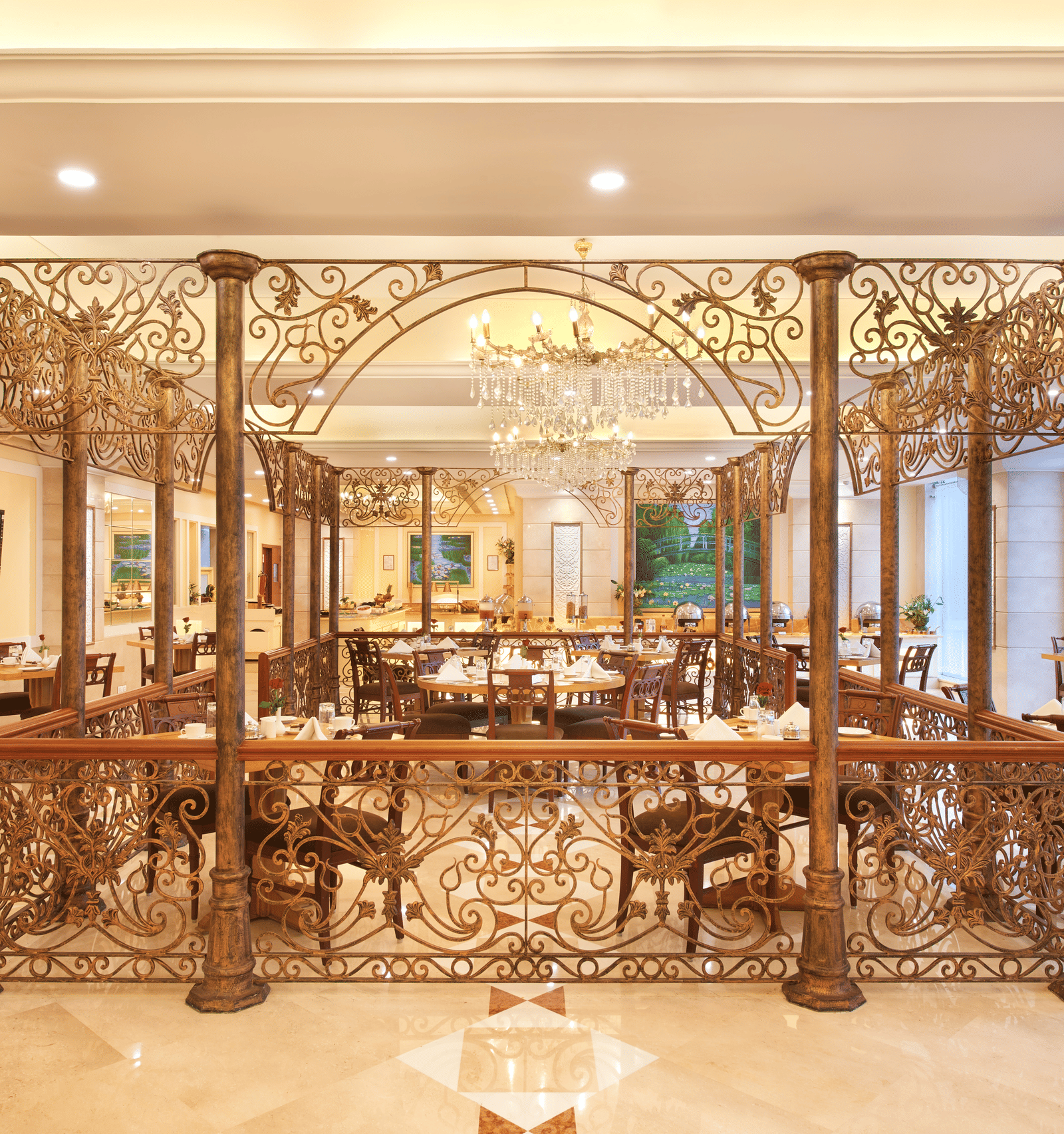 An image of a sectioned dining area with dining tables and chairs at Accord Puducherry